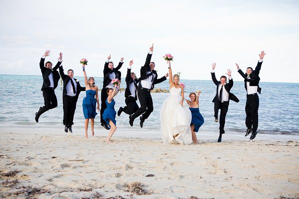 posed jumping wedding photo