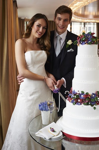 bride groom cutting wedding cake